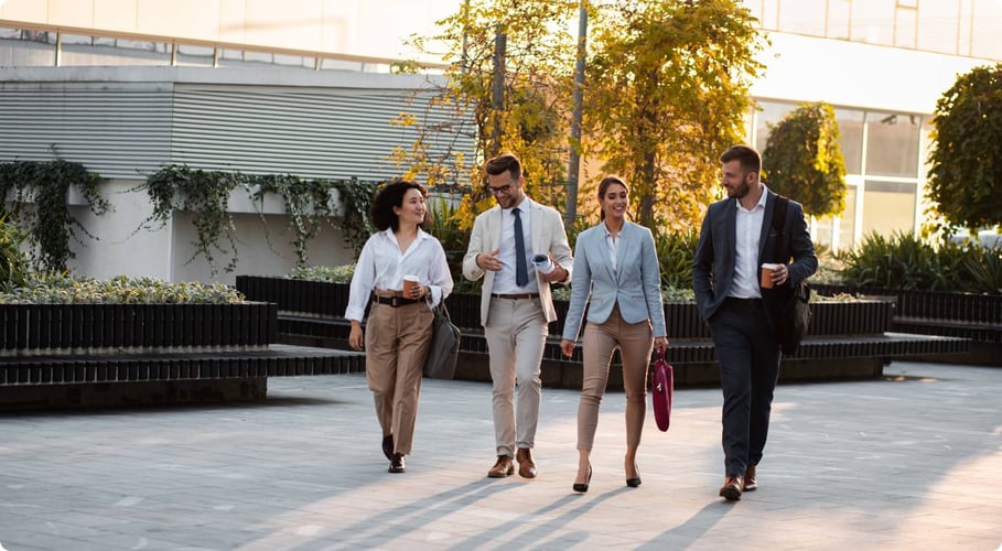 Group of business people walking outside building